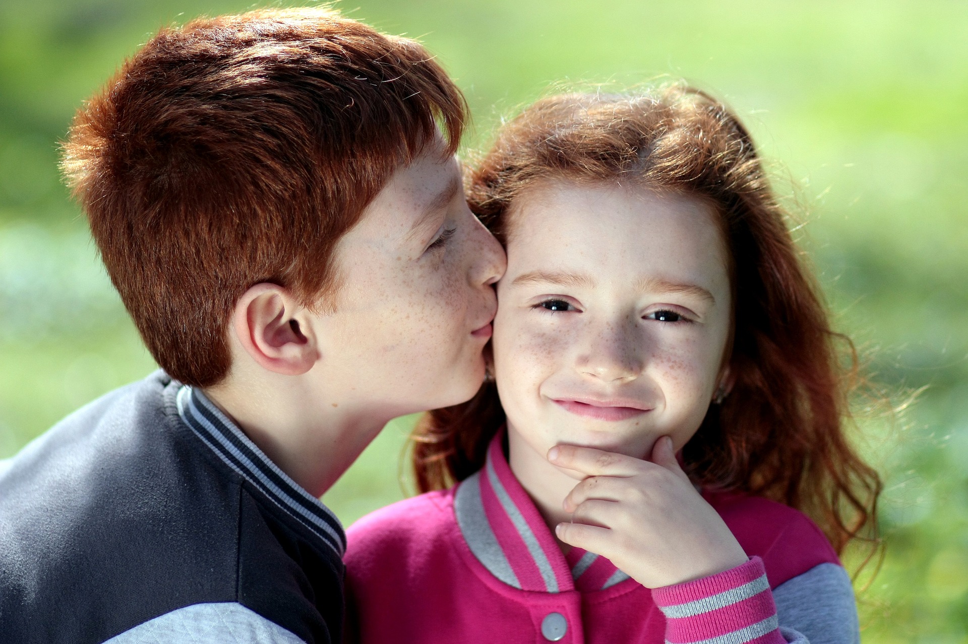 red headed brother kissing red headed sister