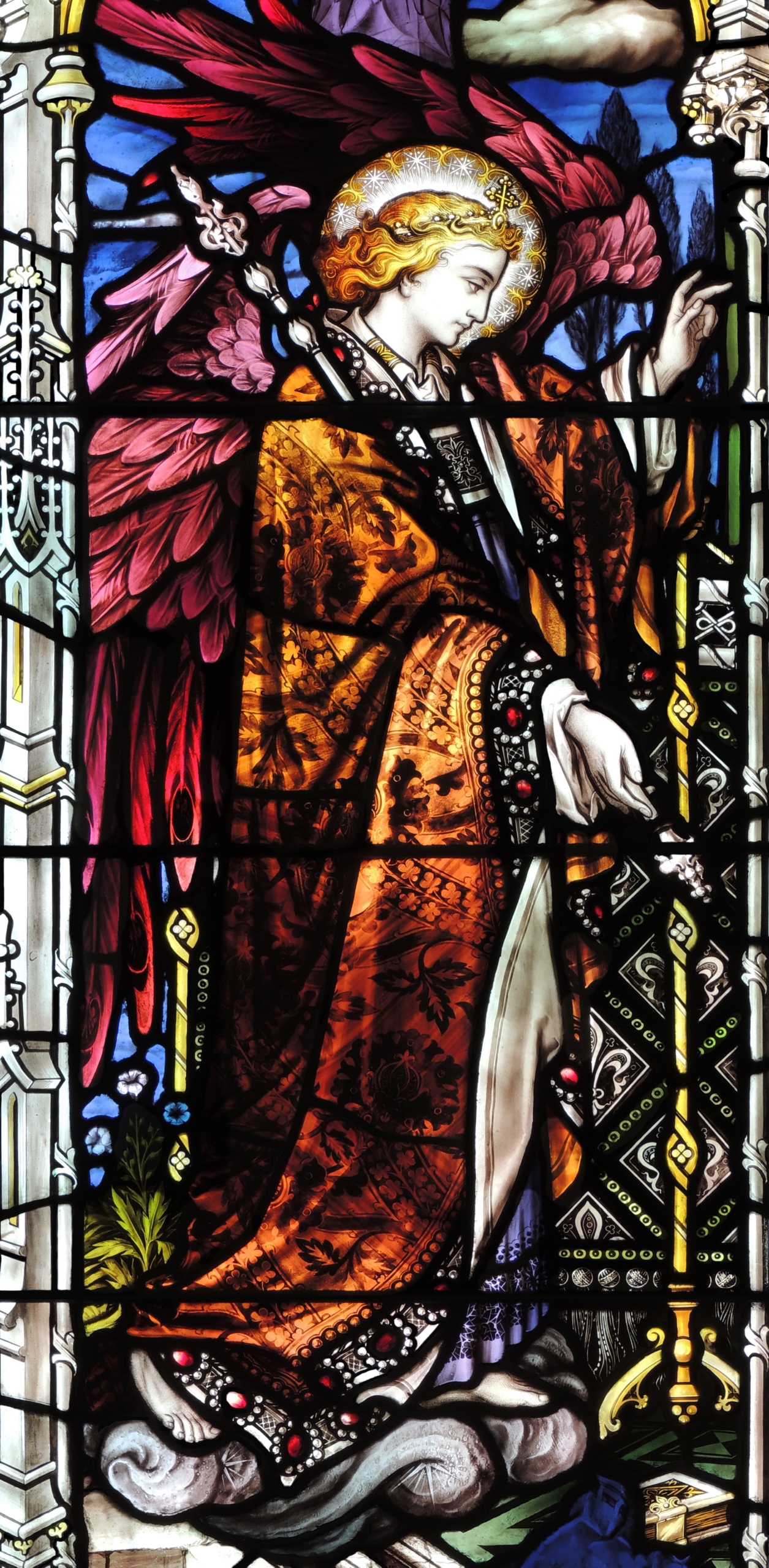 stained glass window of bright crowned angel with scepter blessing