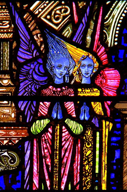 Harry Clarke stained glass window of Cherubim angels with bright wings and hair