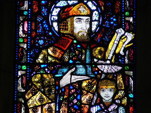 Harry Clarke stained glass window of St. Declan with church, sword and child