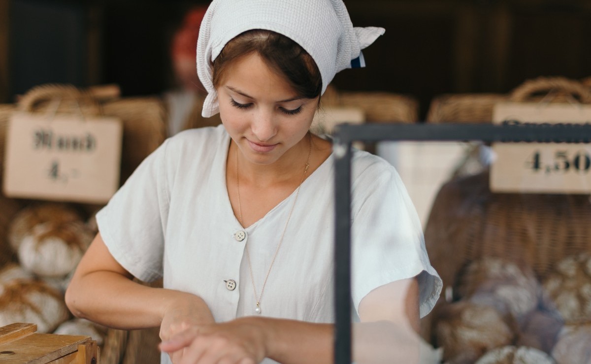 Amish girl cutting bread