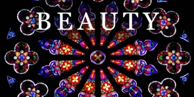 red stained glass with word Beauty superimposed
